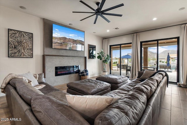 20715 E Watford Dr, Queen Creek, AZ 85142 - living area with a ceiling fan, recessed lighting, and a glass covered fireplace