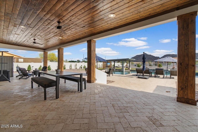 20715 E Watford Dr, Queen Creek, AZ 85142 - view of patio / terrace featuring outdoor dining space, fence, ceiling fan, and an outdoor pool