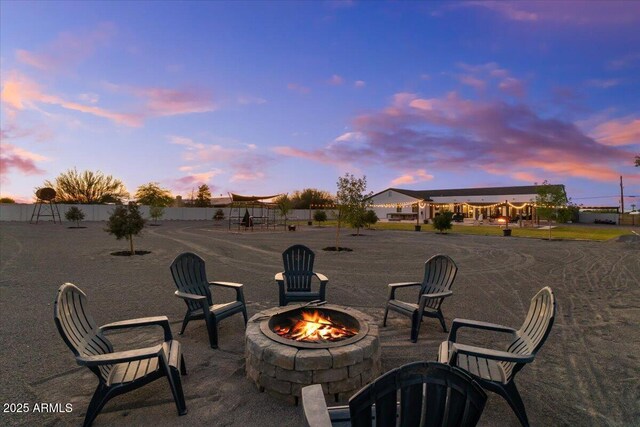 20715 E Watford Dr, Queen Creek, AZ 85142 - patio terrace at dusk featuring an outdoor fire pit