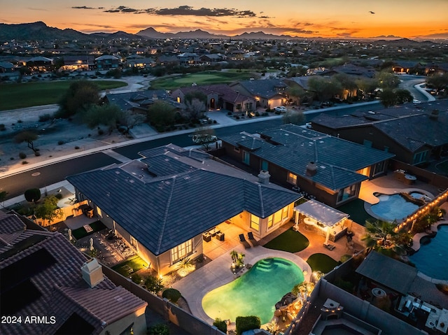 aerial view at dusk featuring a residential view and a mountain view