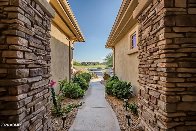 view of side of home with stucco siding and stone siding