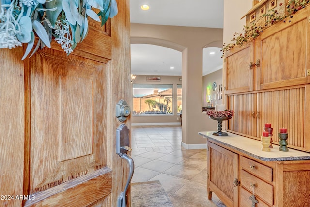 interior space with recessed lighting, arched walkways, light tile patterned floors, and baseboards