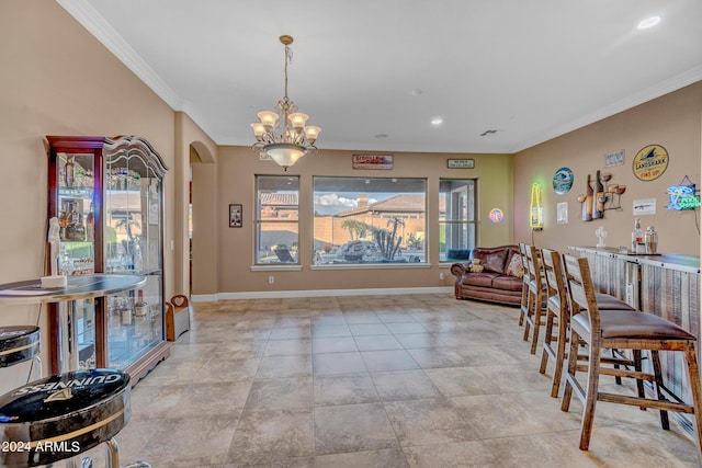 dining room featuring baseboards, arched walkways, an inviting chandelier, ornamental molding, and recessed lighting
