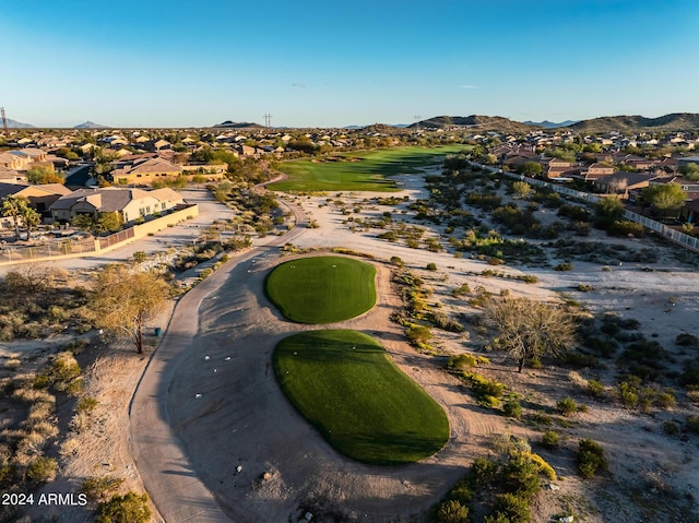 aerial view with golf course view, a mountain view, and a residential view
