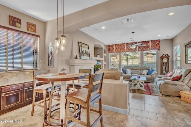 dining area featuring a fireplace, recessed lighting, light tile patterned flooring, visible vents, and ceiling fan