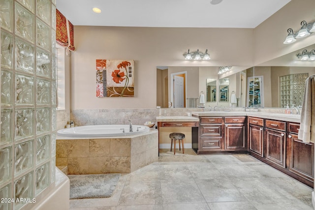 full bathroom with vanity and a garden tub