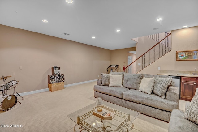 living room featuring indoor wet bar, light colored carpet, visible vents, stairway, and recessed lighting