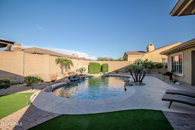 view of swimming pool featuring a fenced in pool, a patio, and a fenced backyard