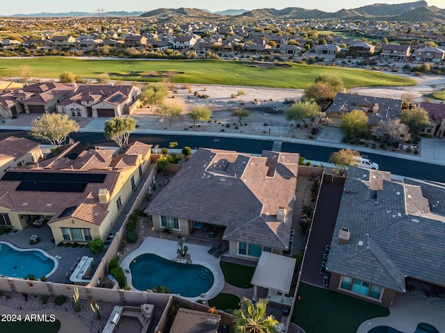 drone / aerial view featuring a mountain view, view of golf course, and a residential view