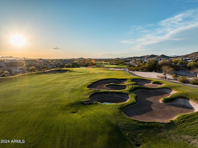 view of property's community with a yard, a mountain view, a residential view, and view of golf course