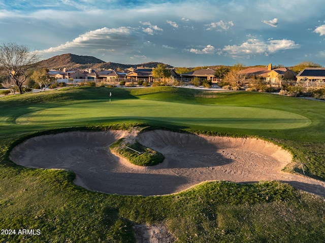 surrounding community featuring a mountain view, view of golf course, and a residential view