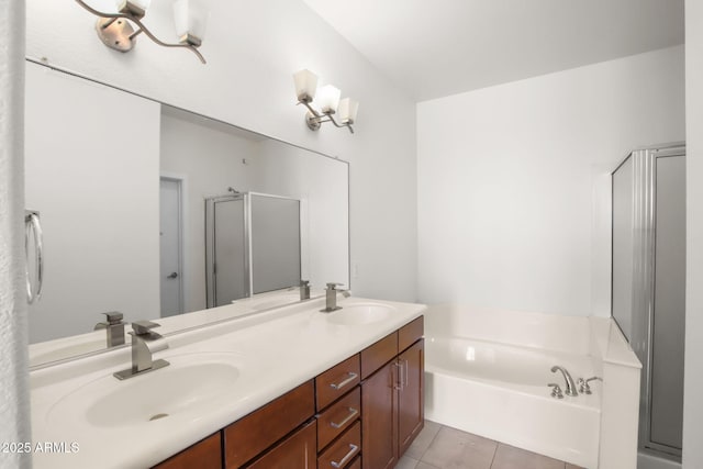 bathroom featuring tile patterned flooring, vanity, and shower with separate bathtub