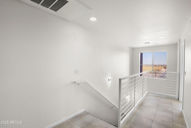 stairs with tile patterned flooring