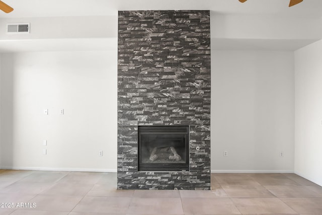 unfurnished living room featuring a tiled fireplace, tile patterned floors, and ceiling fan