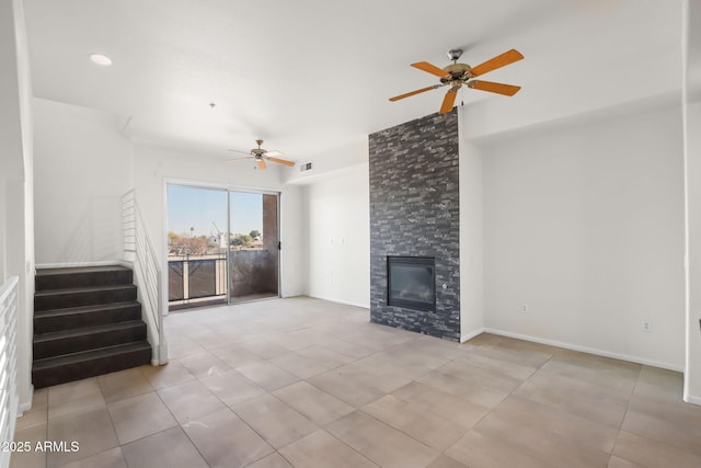 unfurnished living room with a fireplace, ceiling fan, and light tile patterned flooring