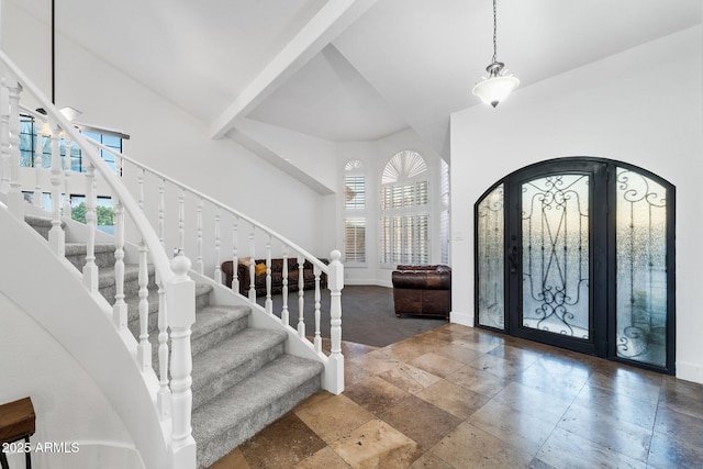entryway featuring stone tile floors, stairway, and baseboards
