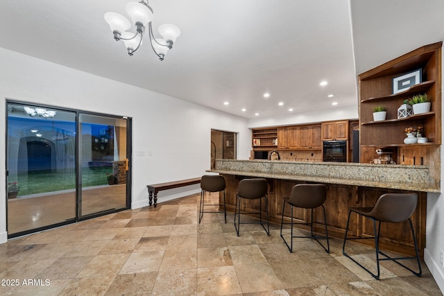 kitchen with recessed lighting, open shelves, oven, stone tile floors, and baseboards