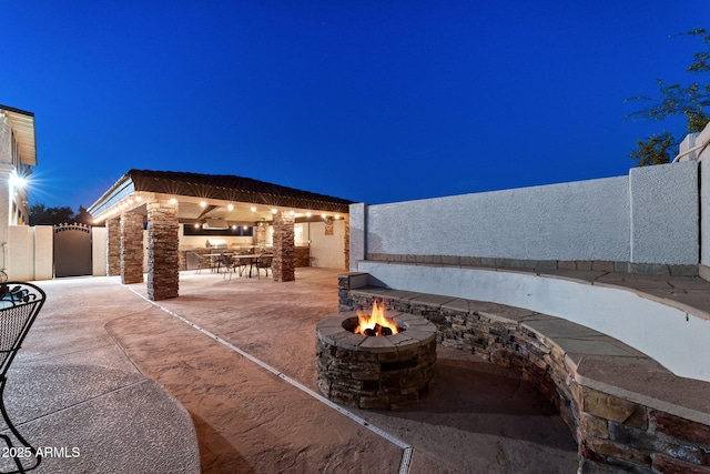 view of patio / terrace featuring a gazebo, fence private yard, and an outdoor fire pit