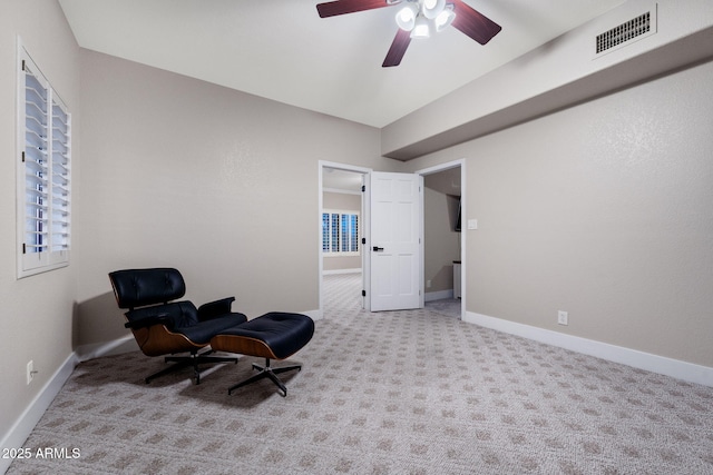 sitting room with carpet flooring, a ceiling fan, visible vents, and baseboards