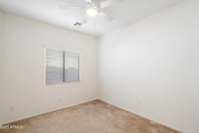 empty room with light carpet, ceiling fan, visible vents, and baseboards