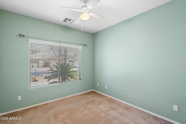 unfurnished room with baseboards, visible vents, a ceiling fan, and carpet flooring