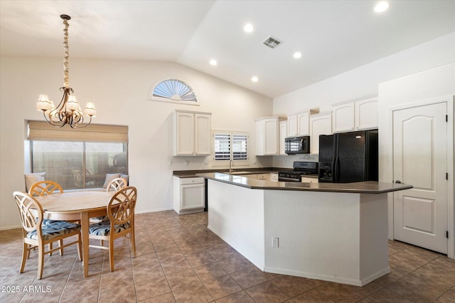 kitchen with dark countertops, black appliances, visible vents, and a chandelier