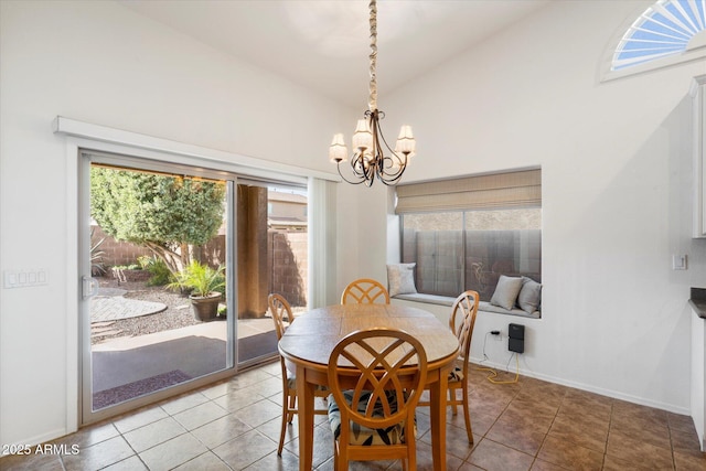 dining area featuring a healthy amount of sunlight, a notable chandelier, baseboards, and tile patterned floors