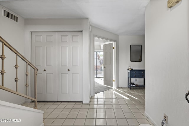 entryway with light tile patterned floors