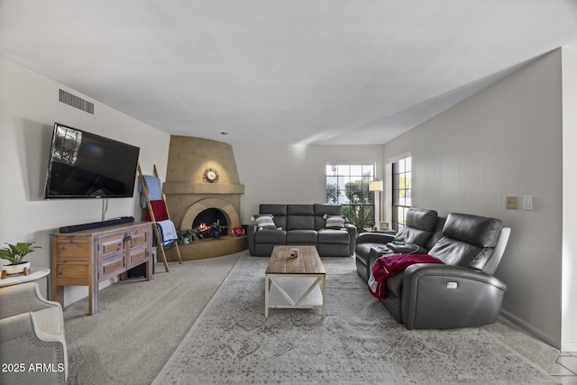 living room with a fireplace and carpet floors