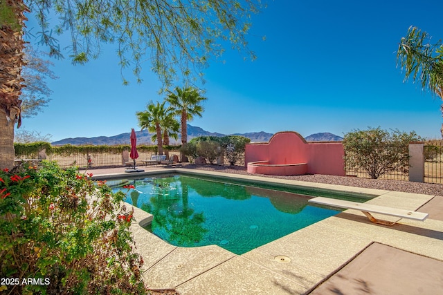 view of swimming pool with a mountain view and a patio area