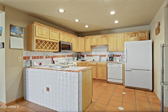 kitchen with white appliances, sink, light brown cabinets, kitchen peninsula, and decorative backsplash