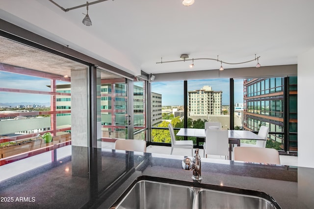 kitchen featuring dark countertops, a city view, and a sink