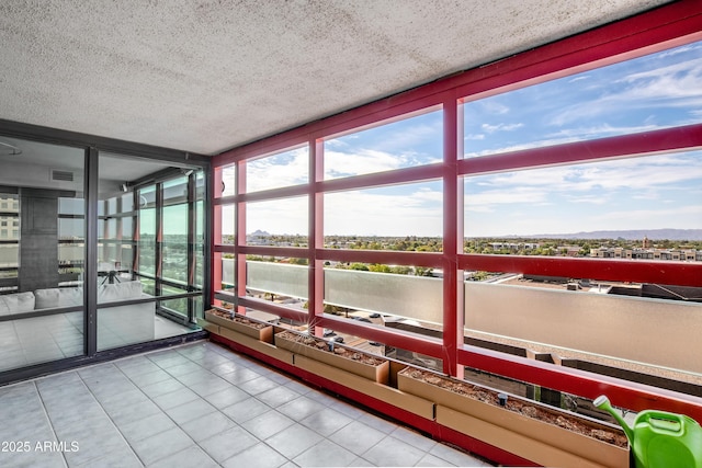 unfurnished sunroom featuring visible vents and plenty of natural light