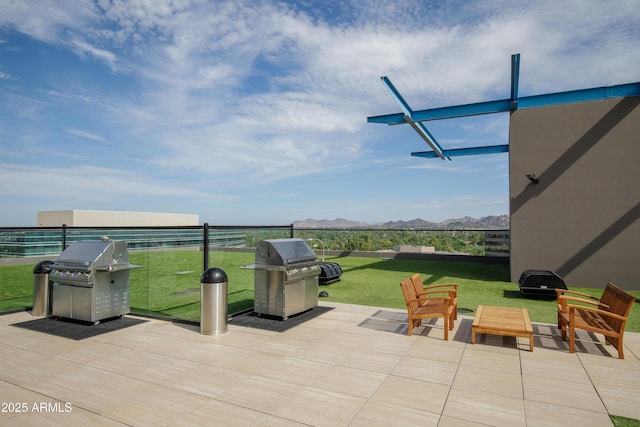 view of patio featuring a grill and a mountain view