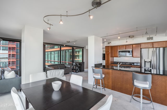 dining area featuring visible vents and track lighting