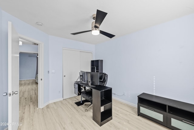 office space featuring wood finished floors, a ceiling fan, and baseboards