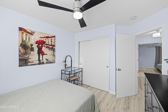 bedroom with light wood-type flooring, a closet, and a ceiling fan