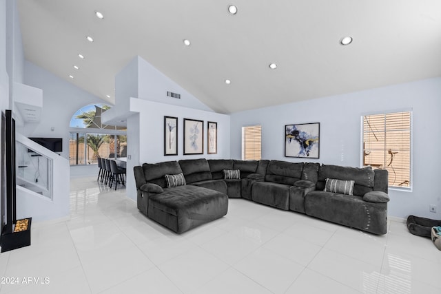 living room with baseboards, recessed lighting, high vaulted ceiling, and tile patterned flooring