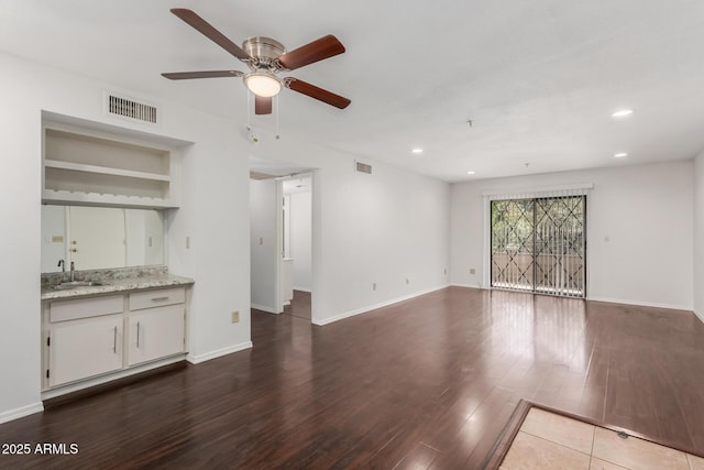 unfurnished living room featuring recessed lighting, visible vents, baseboards, and wood finished floors