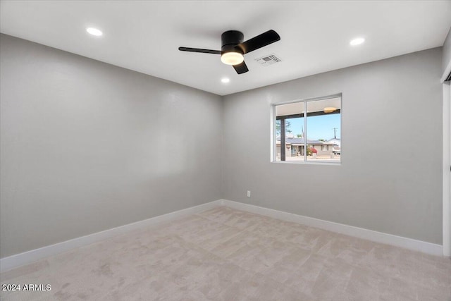 empty room featuring light colored carpet and ceiling fan