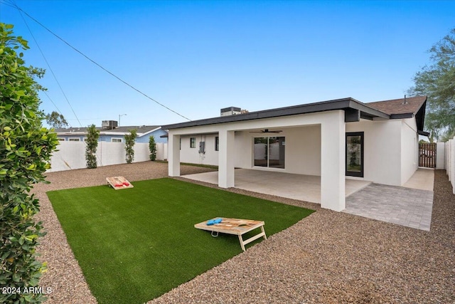 rear view of house featuring a patio area, a yard, and ceiling fan