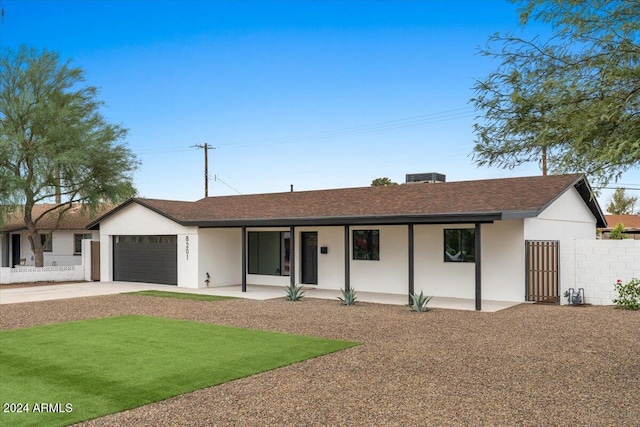 ranch-style home with a front lawn and a garage