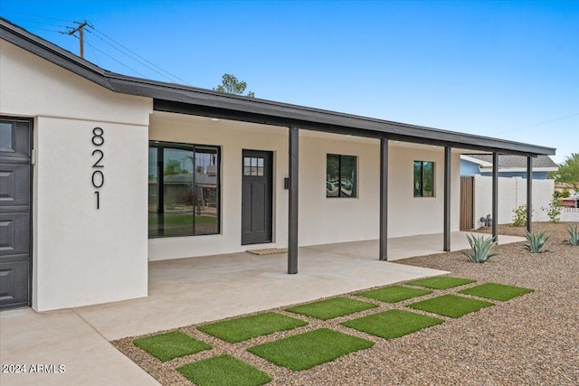 doorway to property featuring a patio area