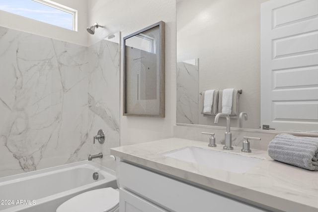 full bathroom with vanity, toilet, and tiled shower / bath