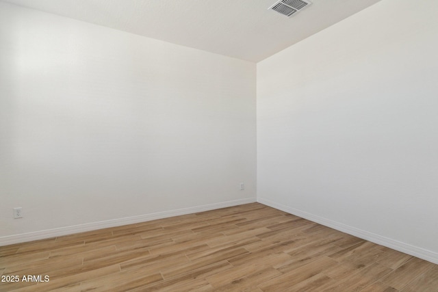 unfurnished room with light hardwood / wood-style flooring