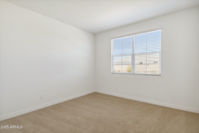 unfurnished room featuring light colored carpet