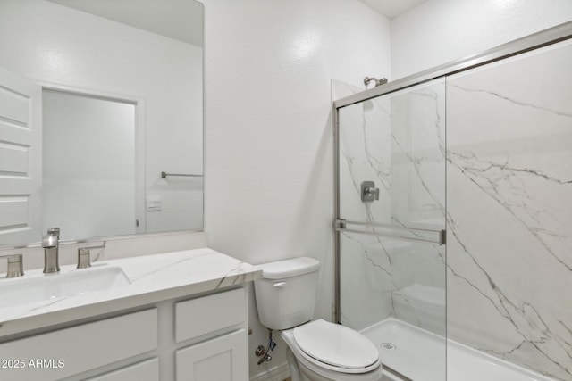 bathroom with vanity, an enclosed shower, and toilet