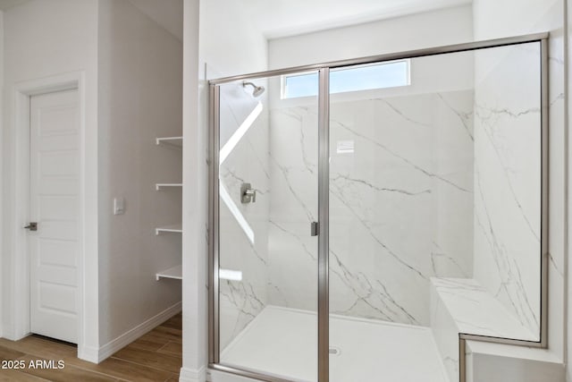 bathroom featuring a shower with shower door