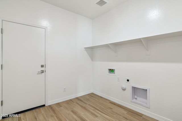 clothes washing area featuring washer hookup, hookup for an electric dryer, hookup for a gas dryer, and light hardwood / wood-style floors