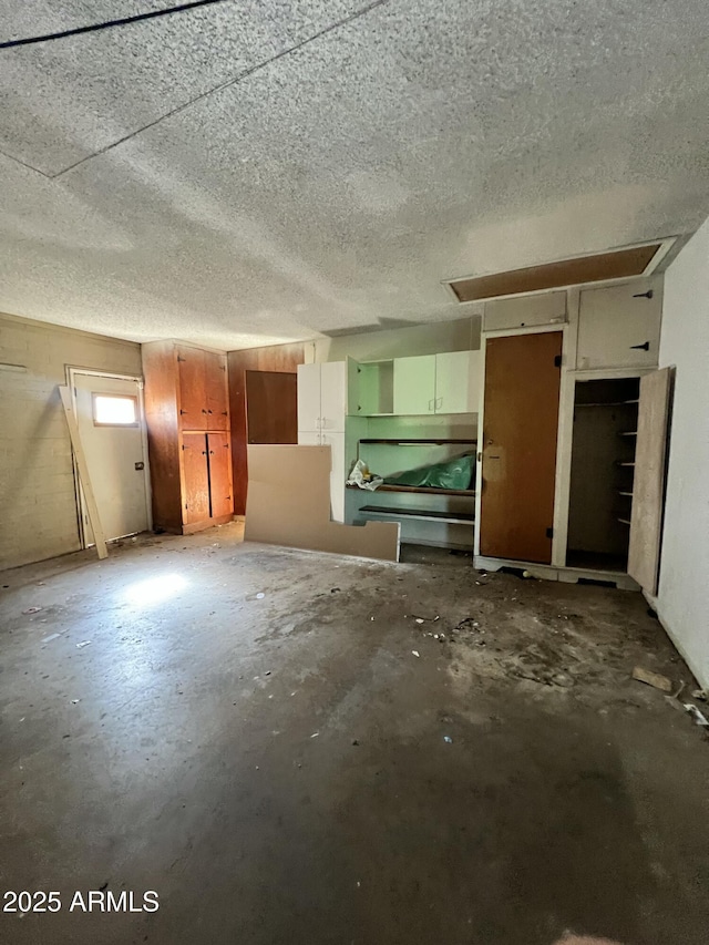 8257 E Cypress St, Scottsdale, AZ 85257 - unfurnished living room featuring concrete floors and a textured ceiling